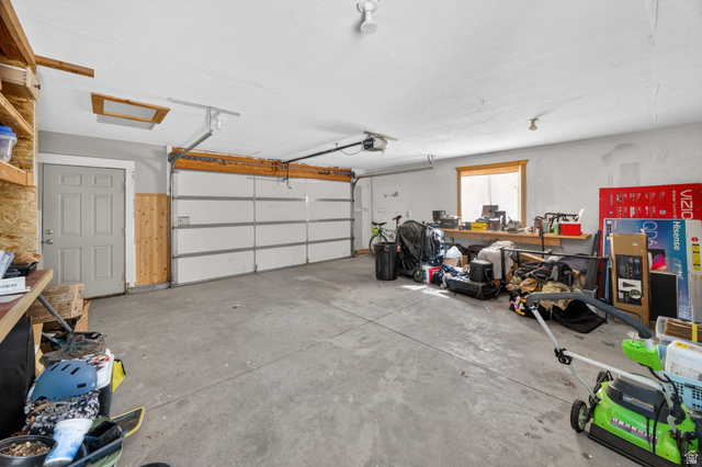 730 East 200 North Logan, UT 84321 - Photo 23 of 28 Spacious garage with a concrete floor, overhead lighting, and a window for natural illumination