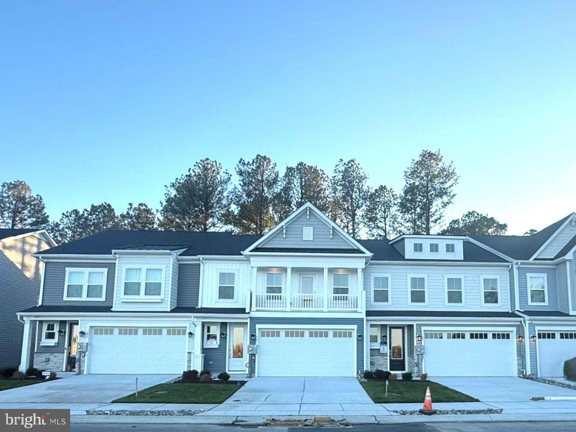 185 Merrick Way Ocean View, DE 19970 - Photo 17 of 19 a front view of a house with yard and parking