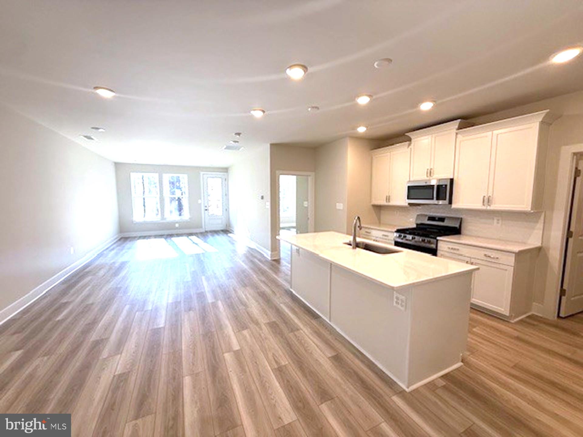 185 Merrick Way Ocean View, DE 19970 - Photo 2 of 19 a kitchen view with wooden floor stainless steel appliances and cabinets
