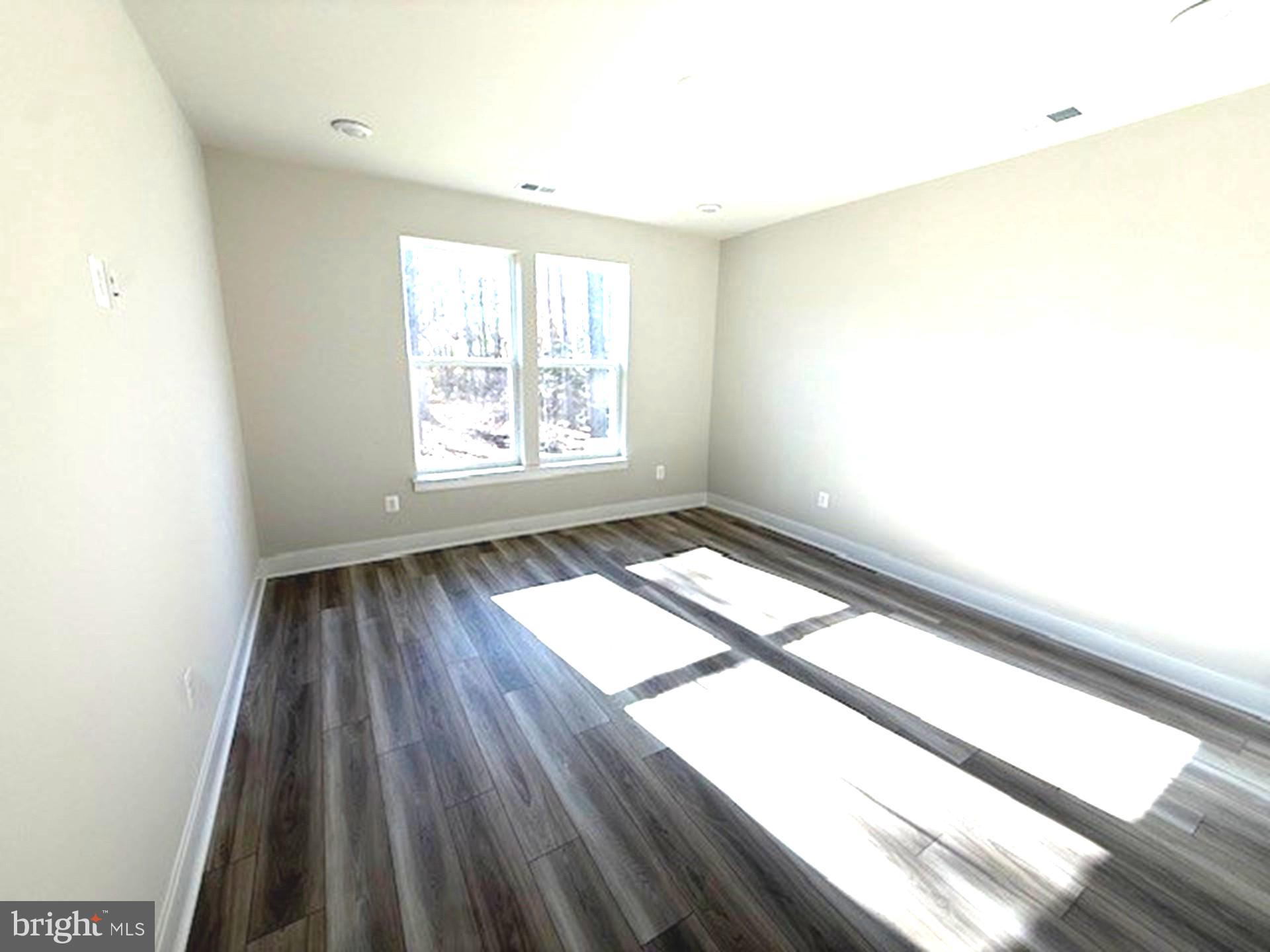 185 Merrick Way Ocean View, DE 19970 - Photo 5 of 19 a view of an empty room and wooden floor