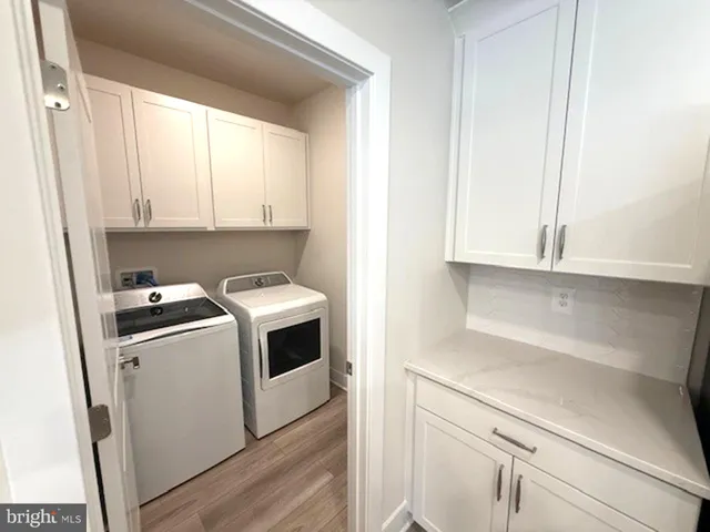 a kitchen with a stove and white cabinets