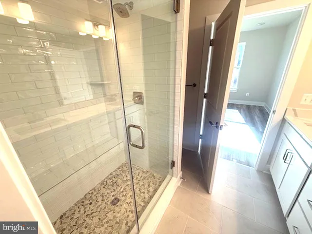 a bathroom with a glass shower door
