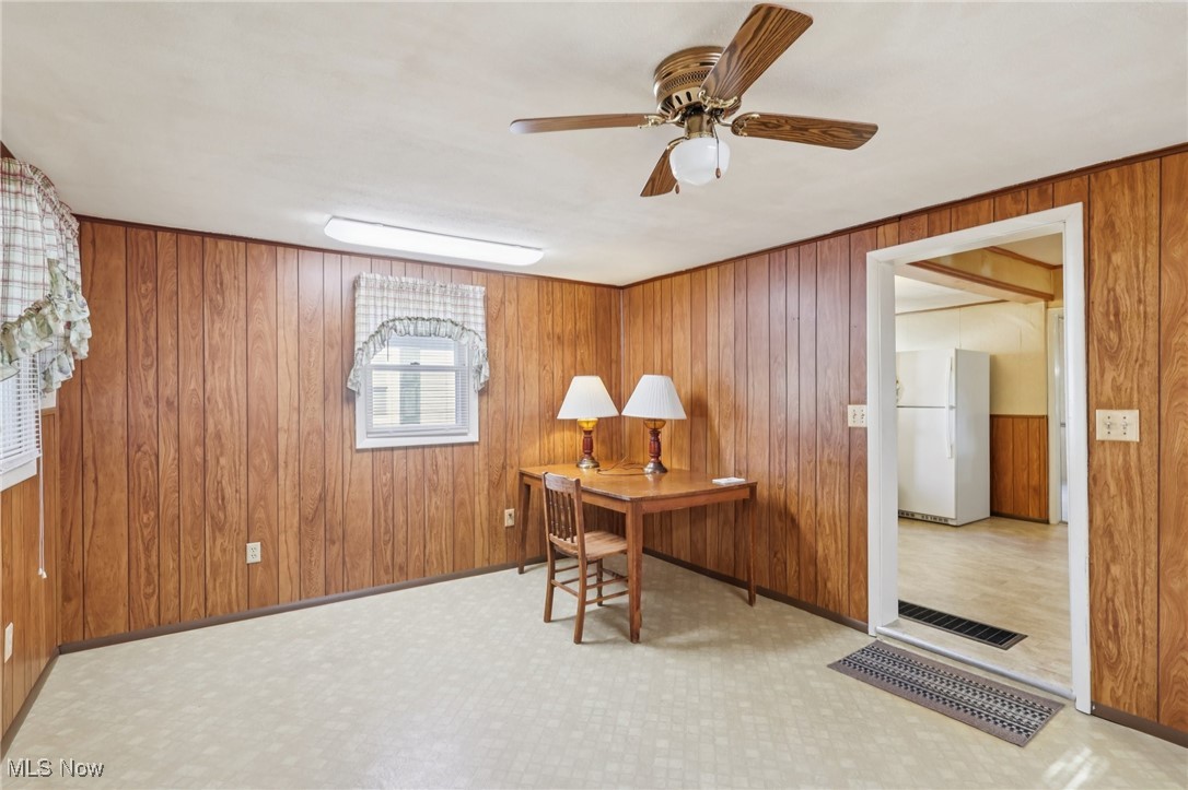 6235 Jefferson Road Ashtabula, OH 44004 - Photo 12 of 40 Office space with wood walls and a ceiling fan
