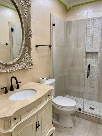 a bathroom with a sink toilet and shower