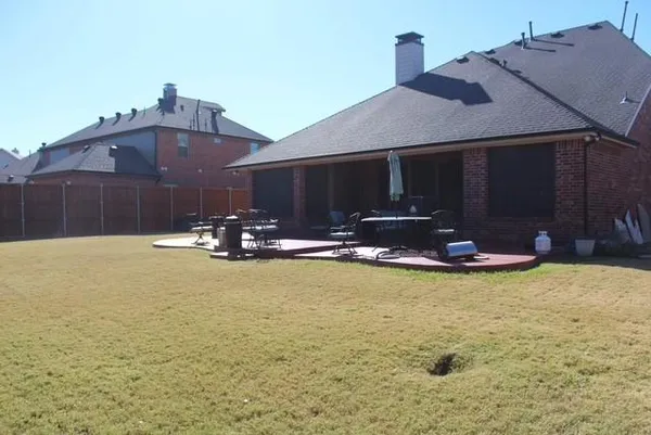 a view of swimming pool with table and chairs under an umbrella