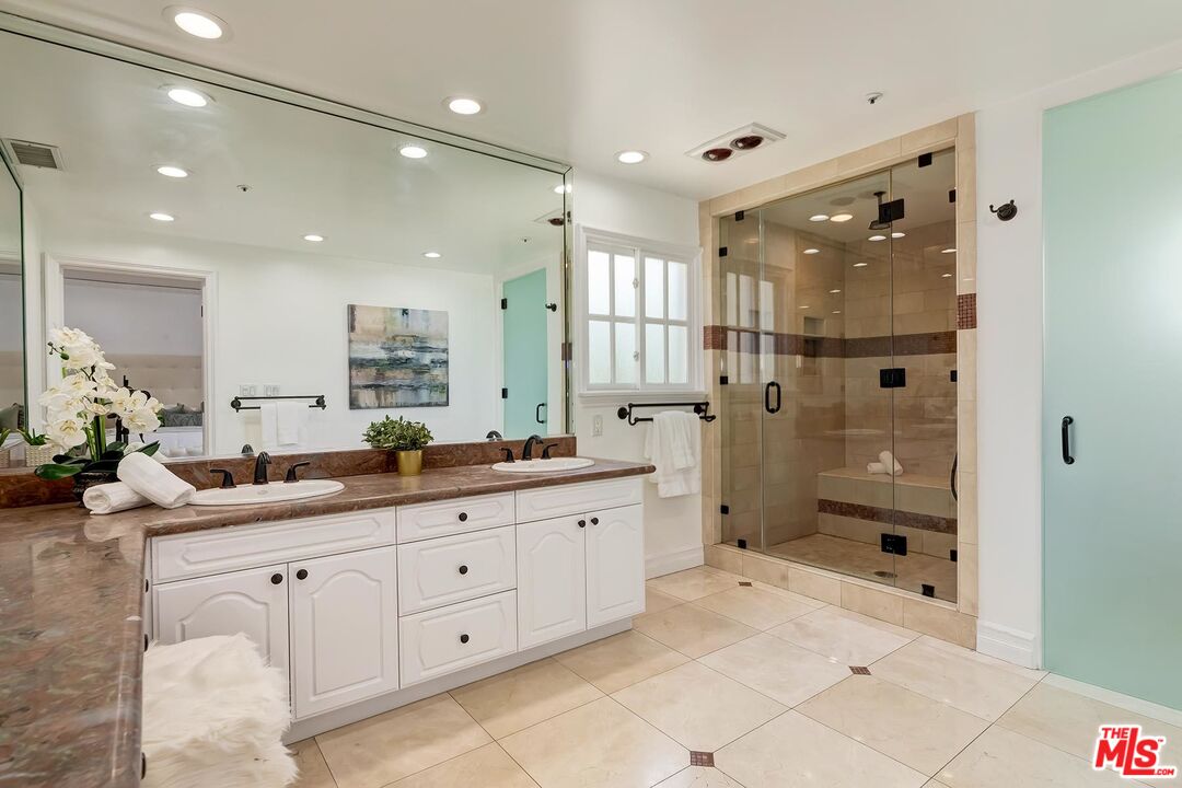 138 North Carson Road Beverly Hills, CA 90211 - Photo 14 of 22 a spacious bathroom with a granite countertop sink mirror and shower