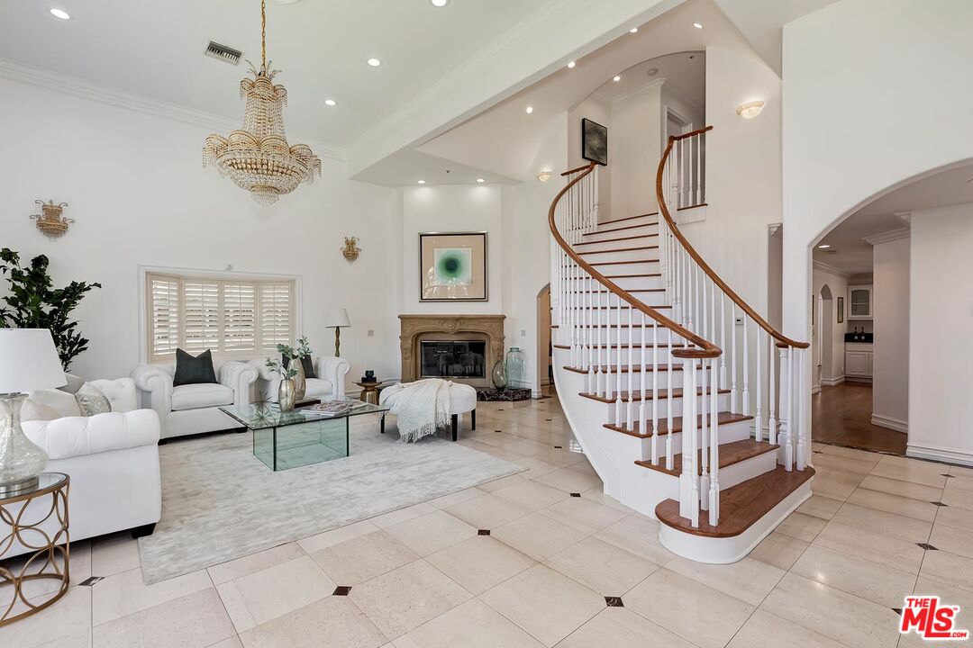 138 North Carson Road Beverly Hills, CA 90211 - Photo 3 of 22 a living room with fireplace furniture and a ceiling fan