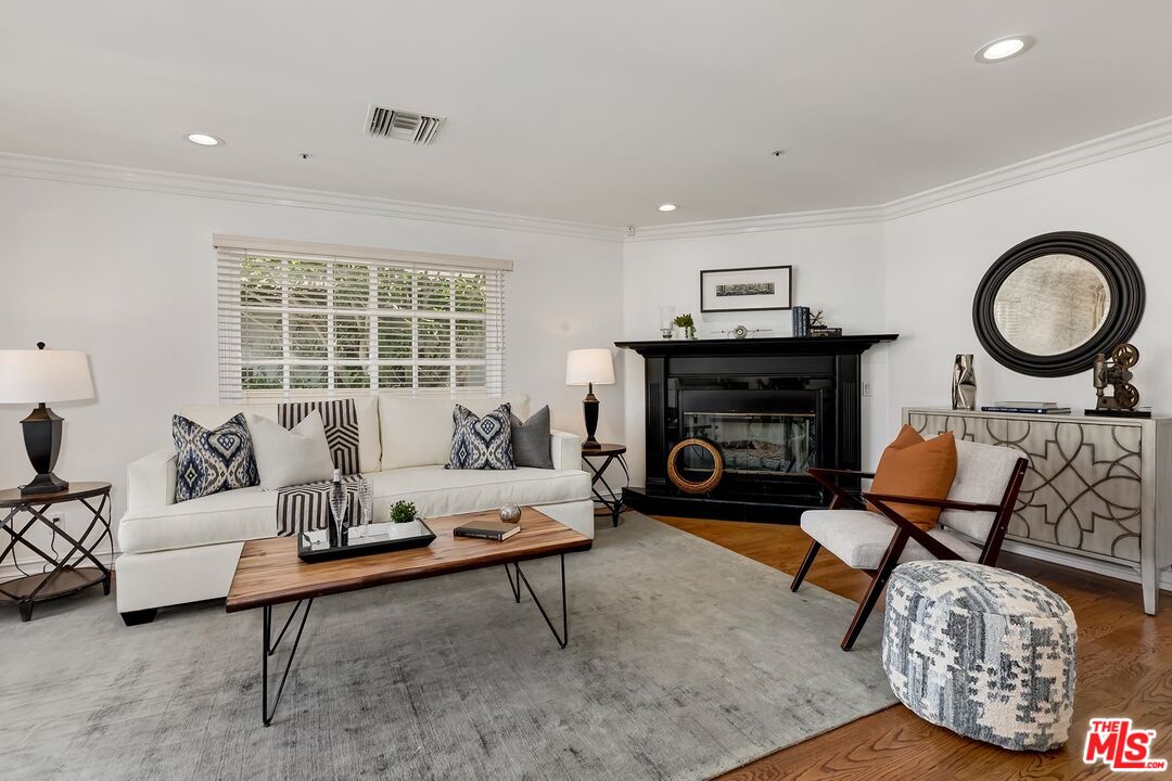 138 North Carson Road Beverly Hills, CA 90211 - Photo 8 of 22 a living room with furniture and a fireplace