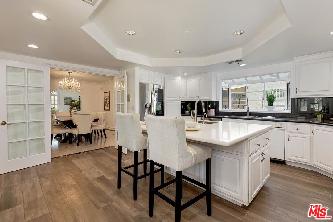 138 North Carson Road Beverly Hills, CA 90211 - Photo 9 of 22 a kitchen with counter space dining table and chairs
