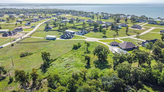 an aerial view of residential houses with outdoor space and swimming pool