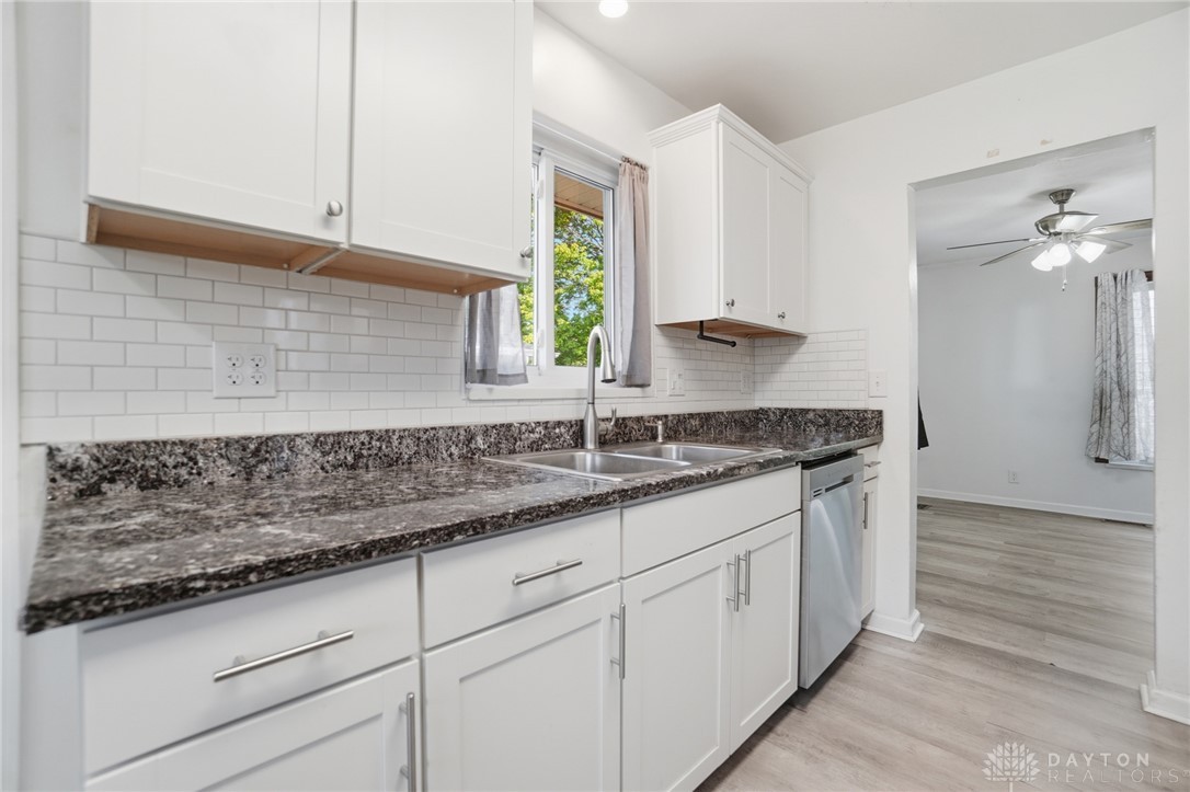 629 Storms Road Dayton, OH 45429 - Photo 23 of 51 This bright kitchen features sleek cabinetry, a double basin sink, and ample countertop space.
