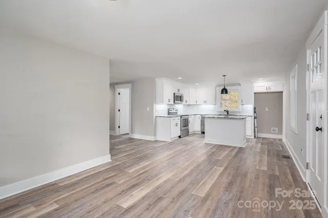 a view of kitchen with wooden floor