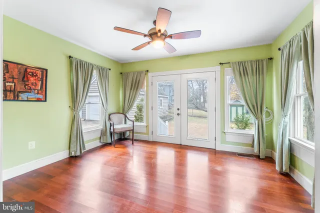 a view of an entryway with wooden floor and a livingroom