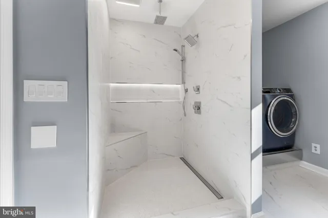 a bathroom with a granite countertop shower and a sink