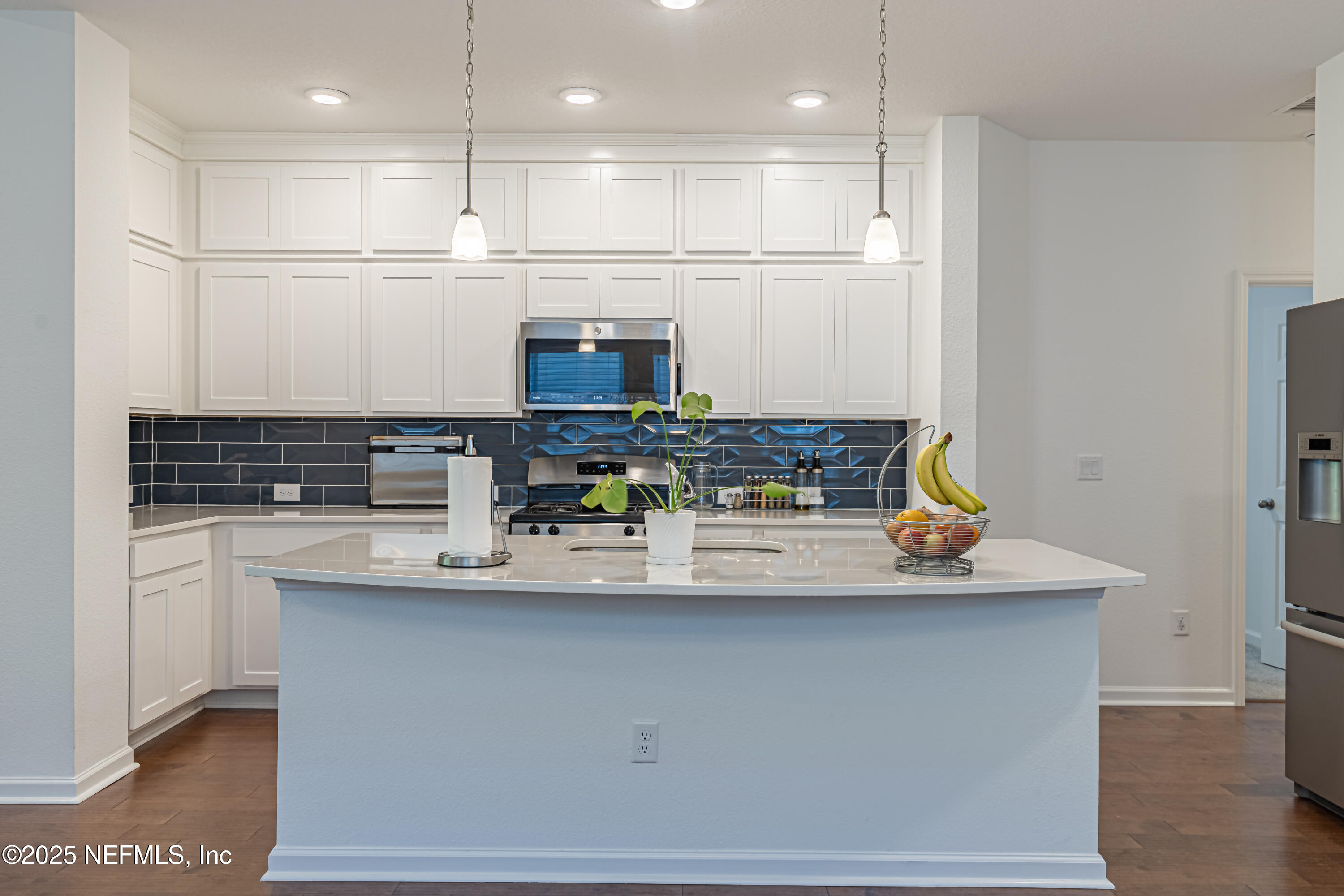 383 Windswept Way Street St. Augustine, FL 32092 - Photo 13 of 34 a kitchen with stainless steel appliances granite countertop a sink and a white cabinets