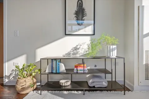 a bedroom with a bed and a painting on the wall