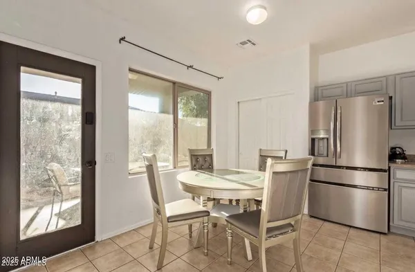 a dining room with furniture and a window