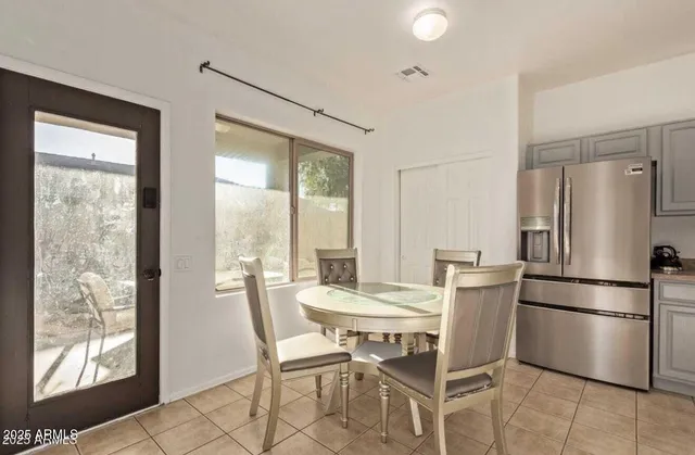 a dining room with furniture and a window