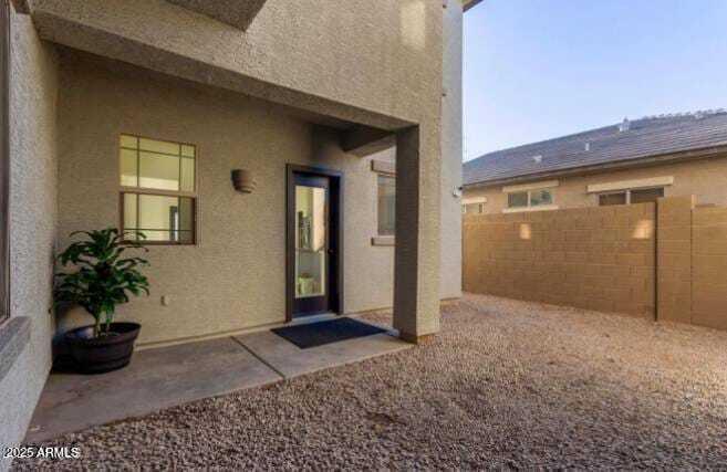 9171 West Berkeley Road Phoenix, AZ 85037 - Photo 7 of 13 a view of a house with a potted plant and a window