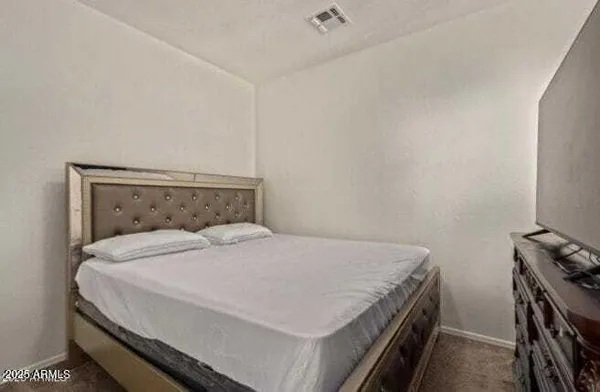 a bed sitting in a bedroom next to a window