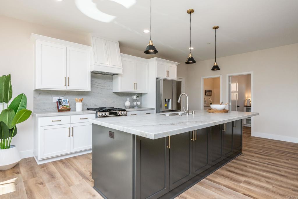 1904 Grey Rabbit Hollow Lane Fallbrook, CA 92028 - Photo 17 of 67 a kitchen with stainless steel appliances granite countertop a sink a stove and a wooden floors