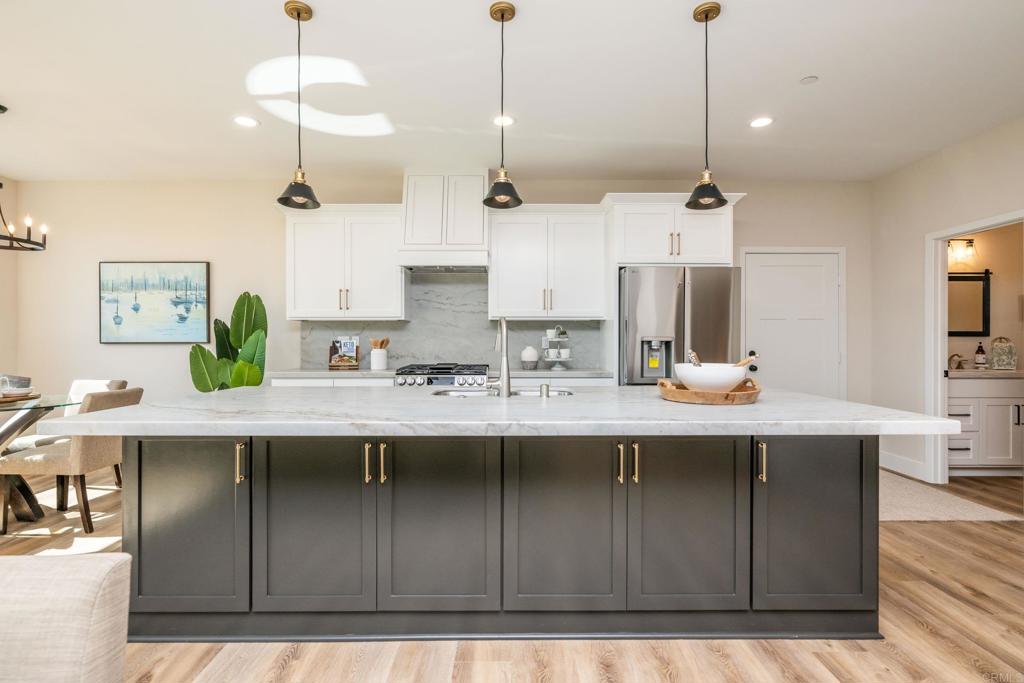 1904 Grey Rabbit Hollow Lane Fallbrook, CA 92028 - Photo 22 of 67 a kitchen with kitchen island granite countertop a sink a counter space appliances and cabinets