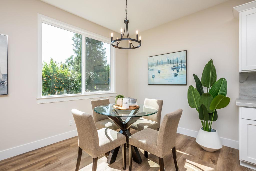 1904 Grey Rabbit Hollow Lane Fallbrook, CA 92028 - Photo 27 of 67 a dining room with furniture potted plants and wooden floor