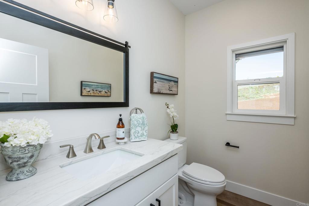 1904 Grey Rabbit Hollow Lane Fallbrook, CA 92028 - Photo 33 of 67 a bathroom with a granite countertop toilet sink and mirror