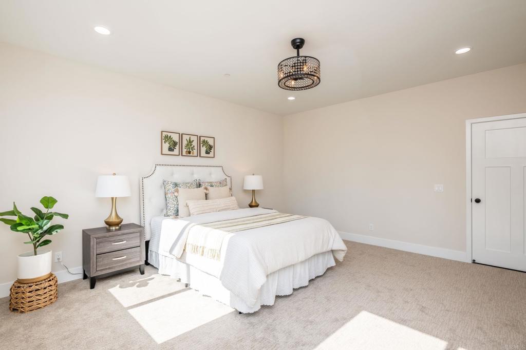 1904 Grey Rabbit Hollow Lane Fallbrook, CA 92028 - Photo 43 of 67 a bedroom with a bed and a potted plant