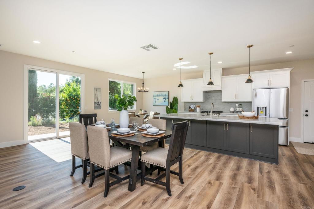 1904 Grey Rabbit Hollow Lane Fallbrook, CA 92028 - Photo 10 of 67 a kitchen with a table chairs stove and cabinets