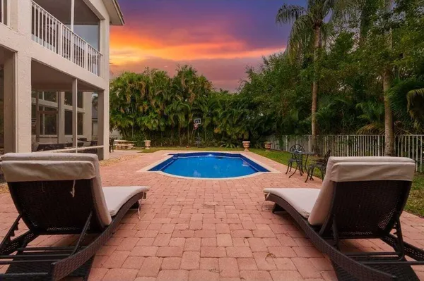 a view of a swimming pool with lounge chair