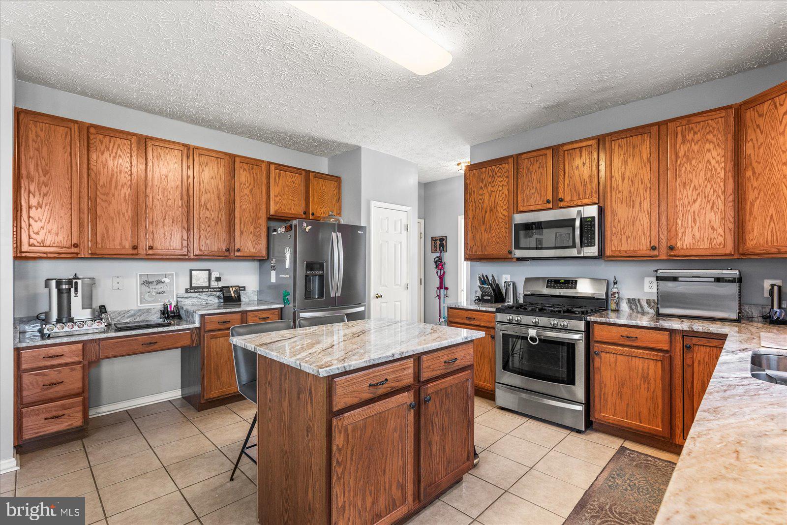 20 Sydney Drive Hanover, PA 17331 - Photo 27 of 73 a kitchen with stainless steel appliances granite countertop a stove sink microwave and refrigerator
