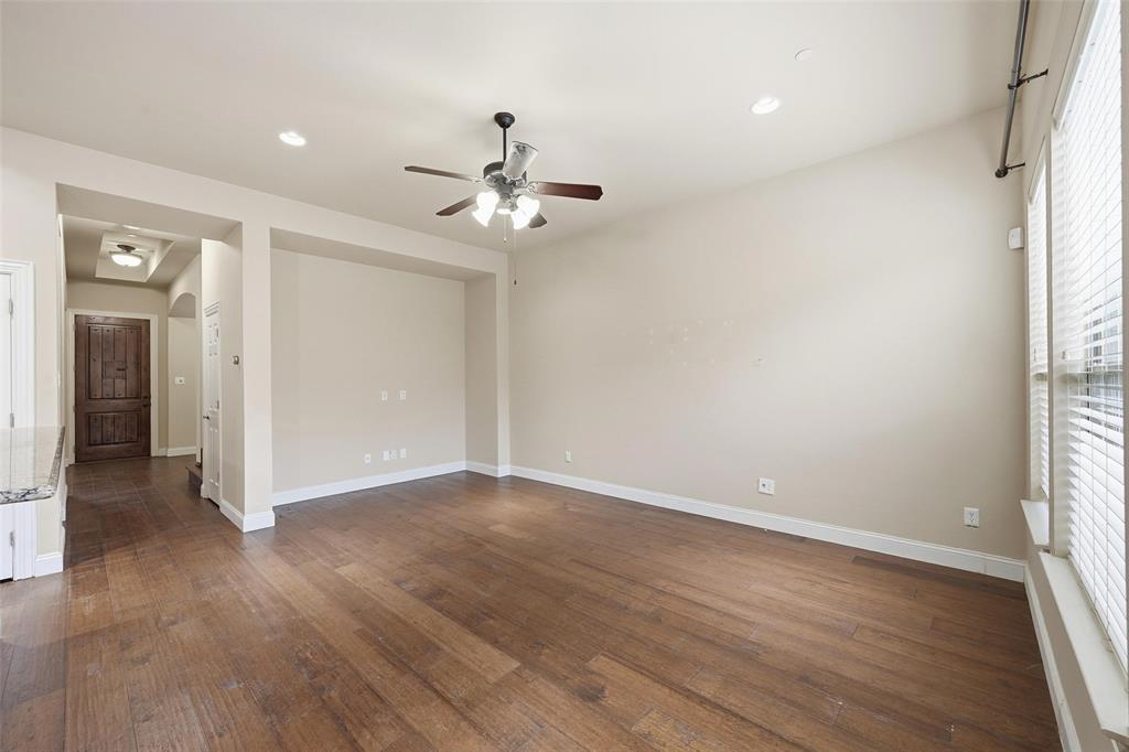 4673 Cecile Road Plano, TX 75024 - Photo 11 of 29 an empty room with wooden floor fan and windows