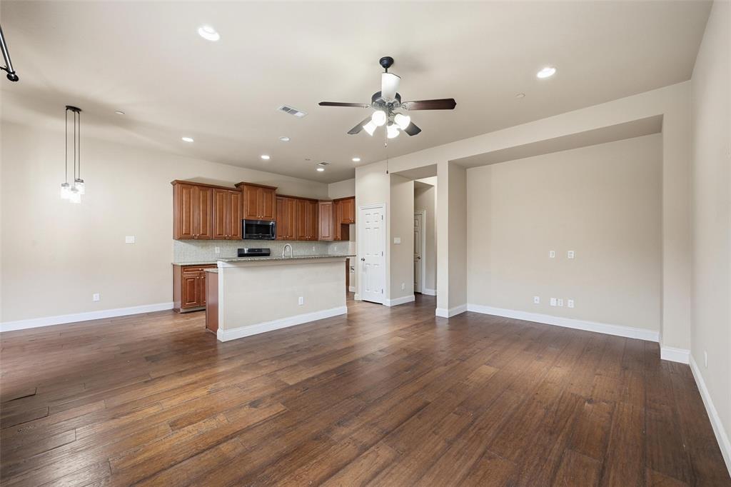 4673 Cecile Road Plano, TX 75024 - Photo 12 of 29 a view of a kitchen with a sink and dishwasher a refrigerator with wooden floor