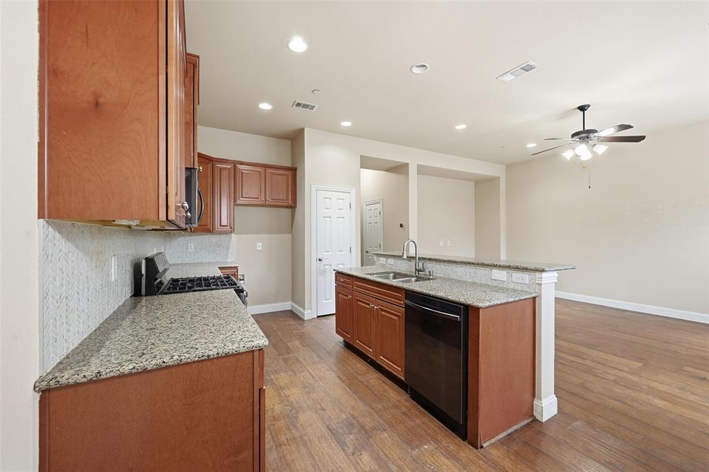 4673 Cecile Road Plano, TX 75024 - Photo 16 of 29 a kitchen with stainless steel appliances granite countertop a stove a sink and a refrigerator