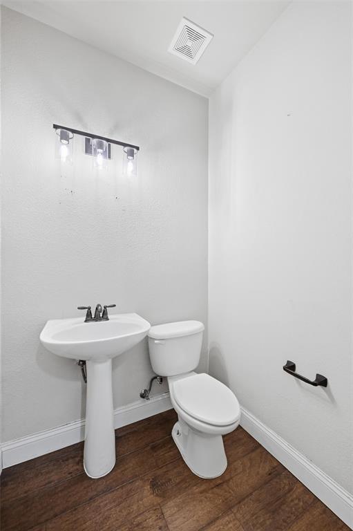 4673 Cecile Road Plano, TX 75024 - Photo 28 of 29 a white toilet sitting next to a white sink
