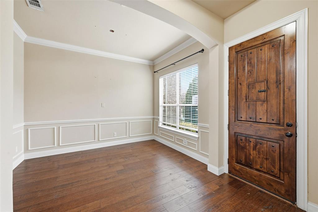 4673 Cecile Road Plano, TX 75024 - Photo 4 of 29 a view of an empty room with wooden floor and a window