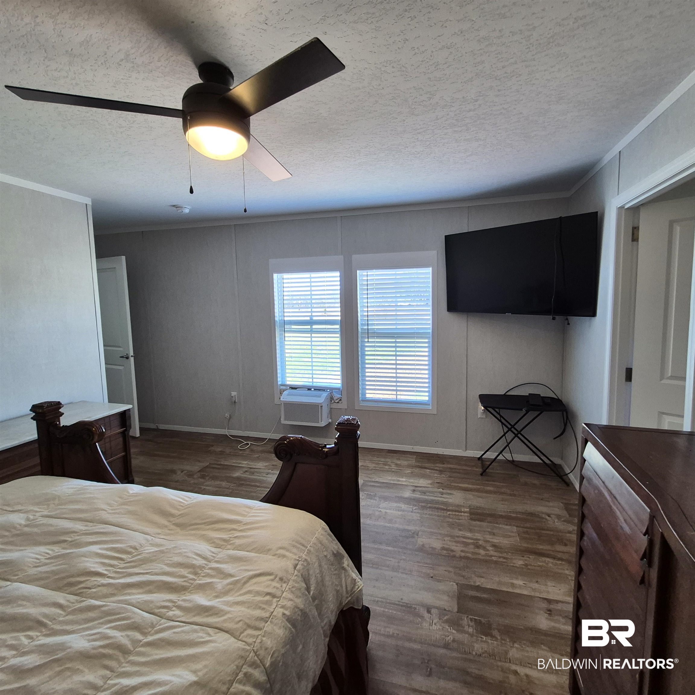 8867 Old Stage Road Repton, AL 36475 - Photo 17 of 37 Bedroom with wood finished floors, a textured ceiling, and a ceiling fan