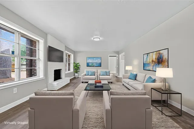 a living room with furniture fireplace and flat screen tv