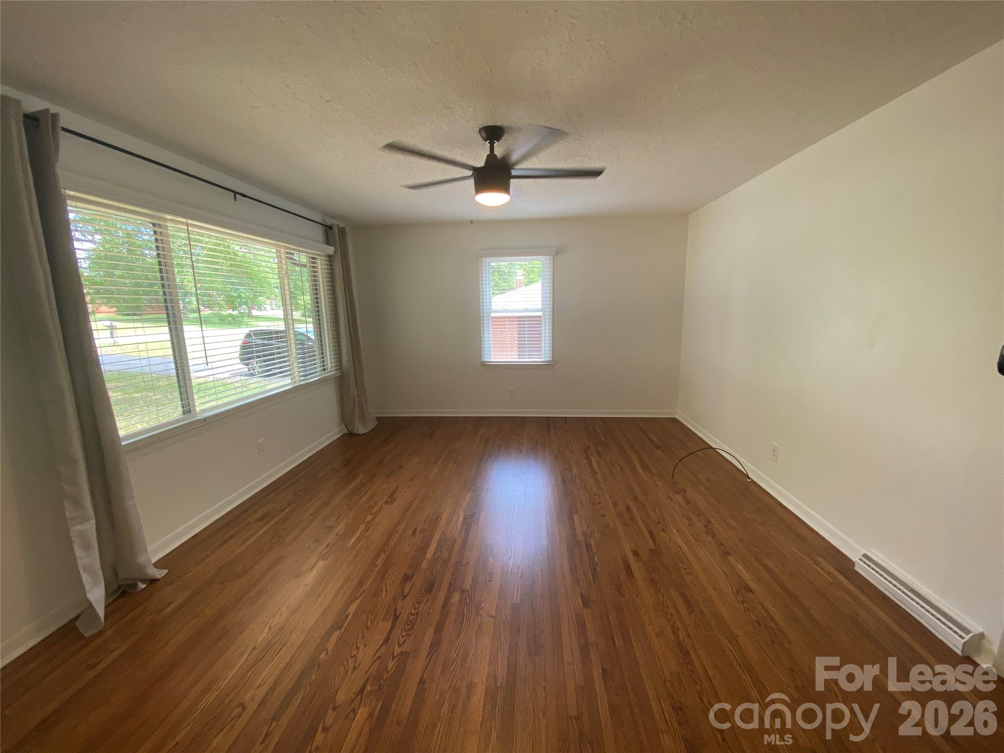 210 Park Road Mount Holly, NC 28120 - Photo 2 of 12 a view of an empty room with wooden floor and a window