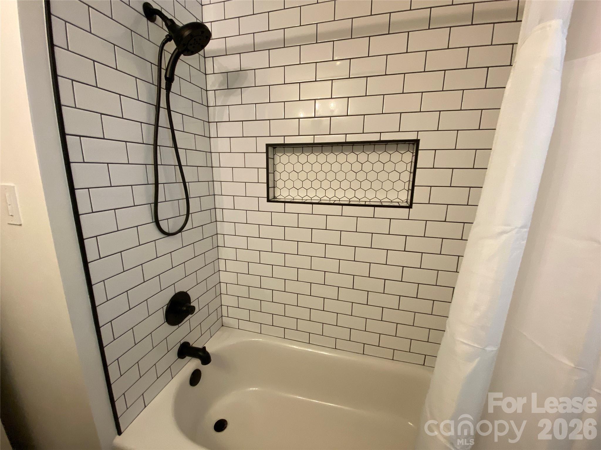 210 Park Road Mount Holly, NC 28120 - Photo 10 of 12 a bathroom with a bathtub and shower