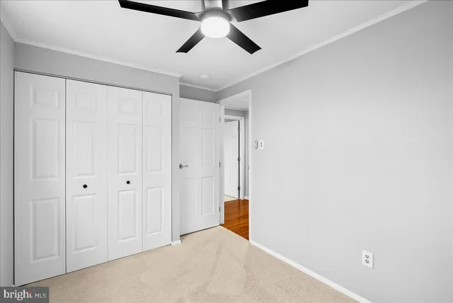 a view of a livingroom with a ceiling fan & window