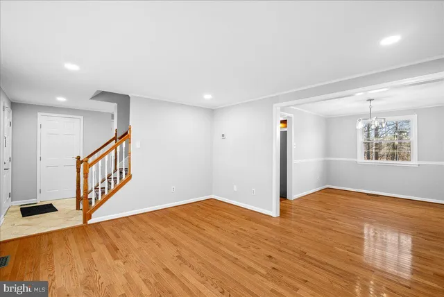 a large kitchen with granite countertop a stove top oven a sink dishwasher and a fireplace with wooden floor