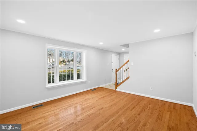 a view of an empty room with a fireplace and a window