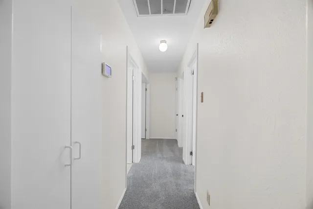 a view of hallway with wooden floor