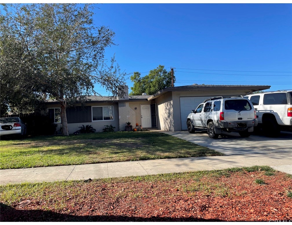 4026 Madrona Road Riverside, CA 92504 - Photo 1 of 1 a front view of a house with a yard