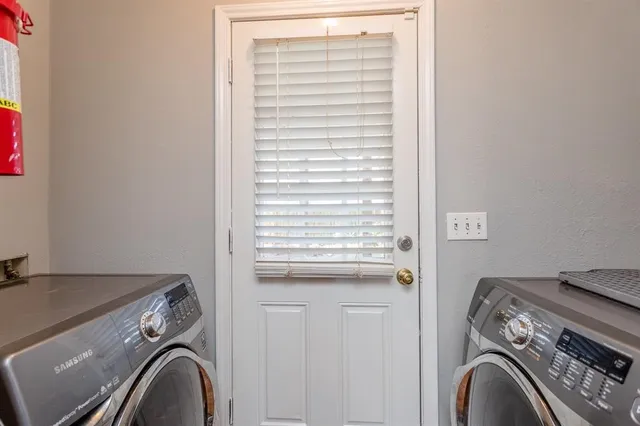 a view of storage and utility room with washer and dryer