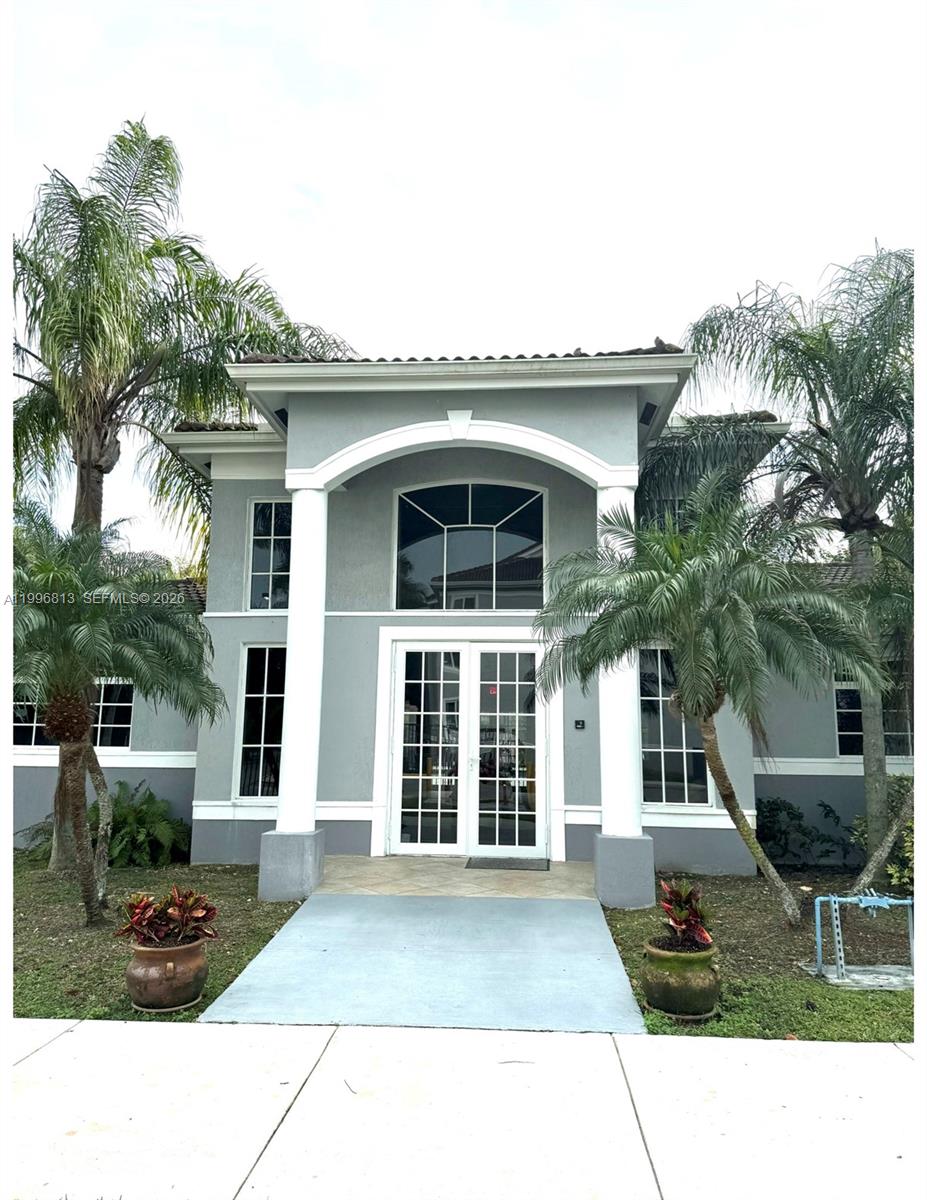 15480 Southwest 284th Street, Unit 2307 Homestead, FL 33033 - Photo 1 of 19 a front view of a house with a garden
