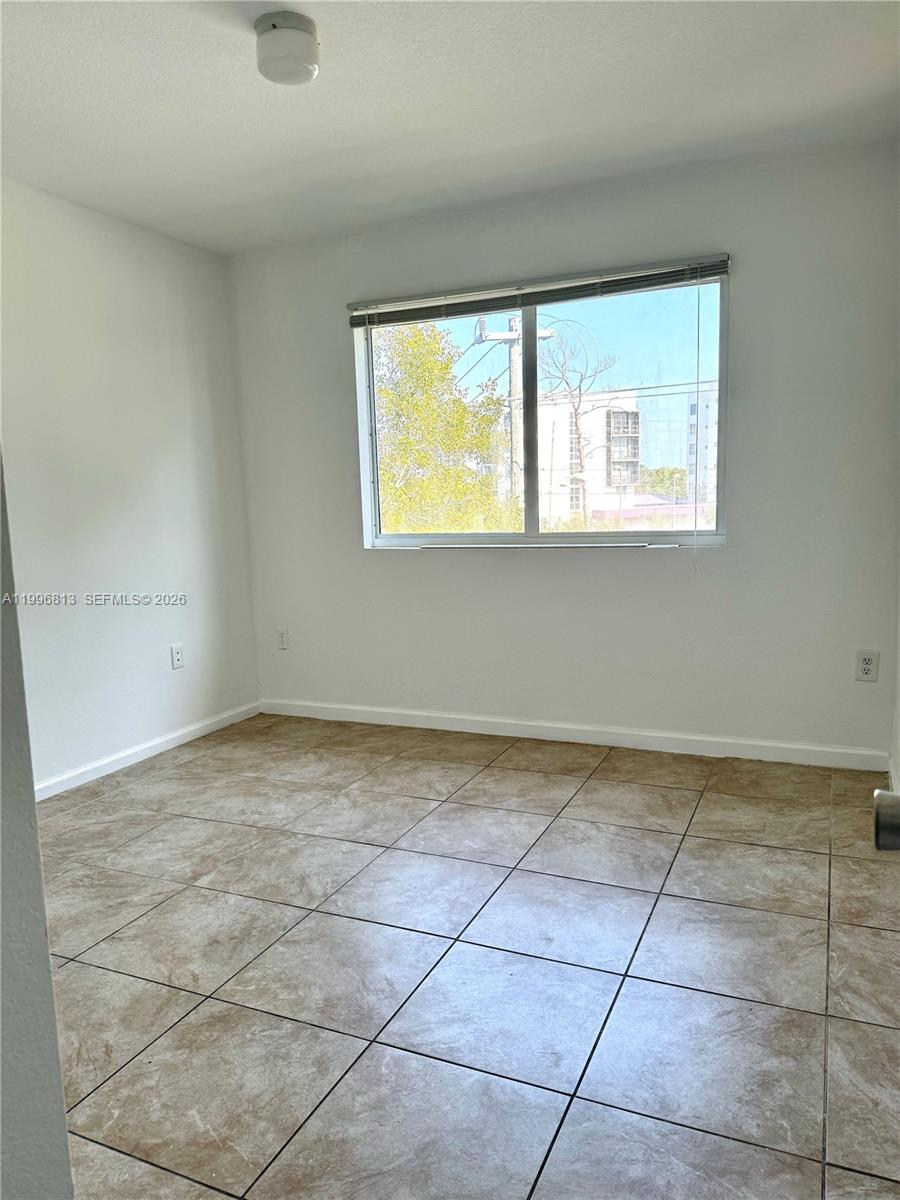 15480 Southwest 284th Street, Unit 2307 Homestead, FL 33033 - Photo 12 of 19 a view of an empty room with a window