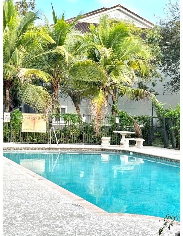 15480 Southwest 284th Street, Unit 2307 Homestead, FL 33033 - Photo 16 of 19 a view of swimming pool with a yard and palm trees